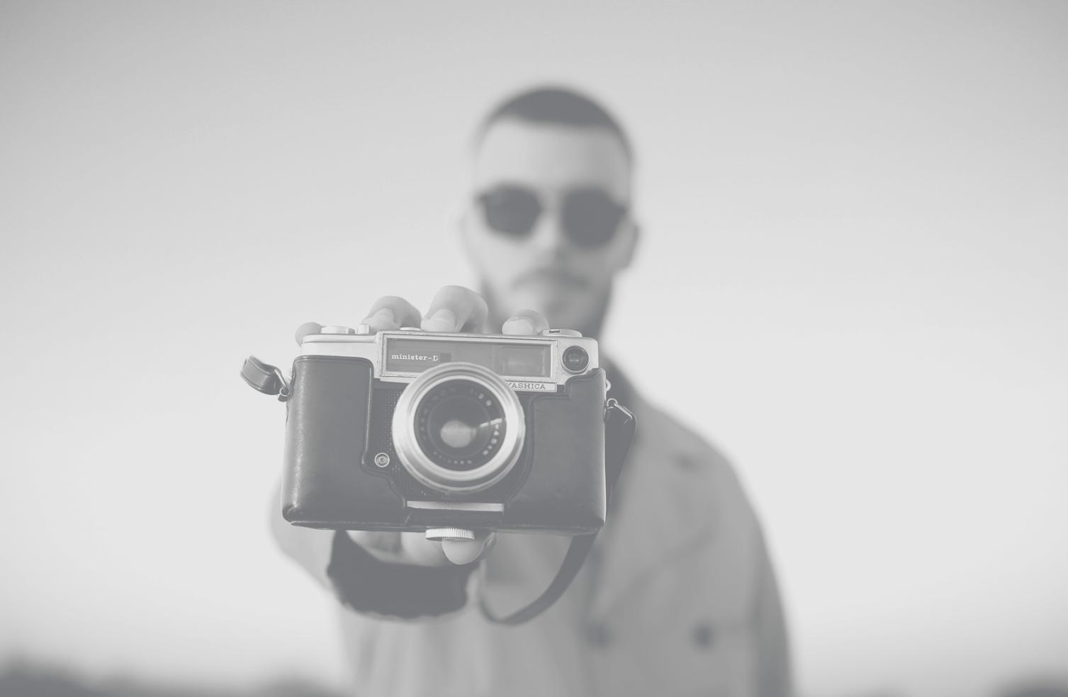 Film editor reviewing footage on professional editing bay with color-accurate monitors and editing control surface