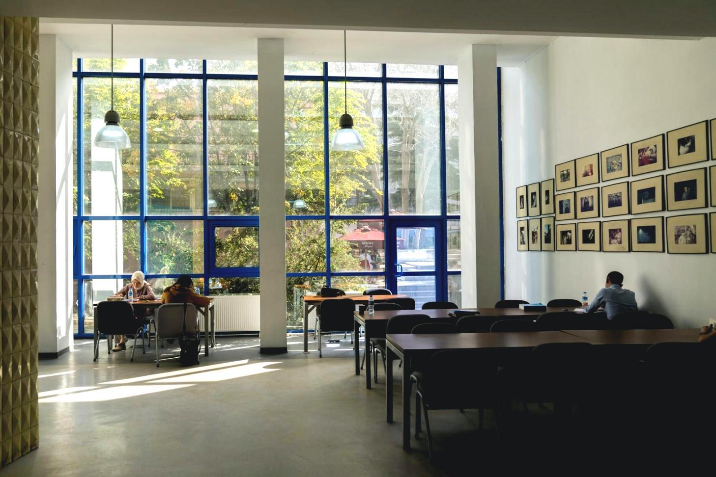 Professional film editing studio setup with multiple monitors displaying video timelines and color correction tools